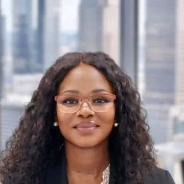 Head-and-shoulders photo of Mimi in glasses, smiling.