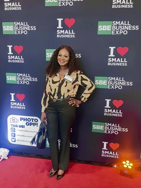 Mimi smiling on the red carpet at the Small Business Expo in Dallas.